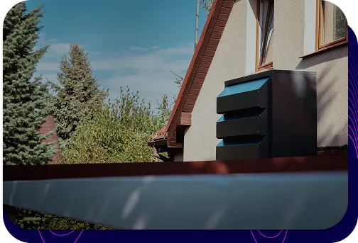 A modern, graphite Silencions s|AC| acoustic enclosure mounted on the wall of a residential building, effectively silencing the air conditioner and improving the aesthetics of the installation.