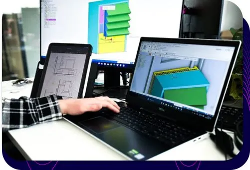 Silencions engineer working on a heat pump enclosure design; a 3D model and technical drawing are visible on the laptop and monitor screens.