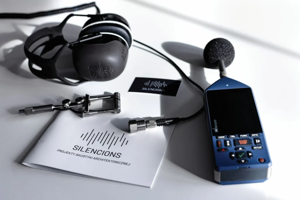 Silencions professional acoustic measurement equipment, including a sound level meter, used to analyse office noise and measure reverberation time.