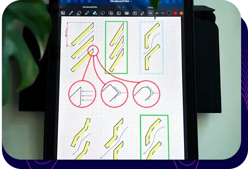 The process of designing a customised enclosure for a heat pump. The tablet displays technical sketches of various internal design options.