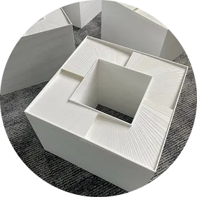 The photo shows customised, white, square sound absorbers for ventilation, made using 3D printing technology.