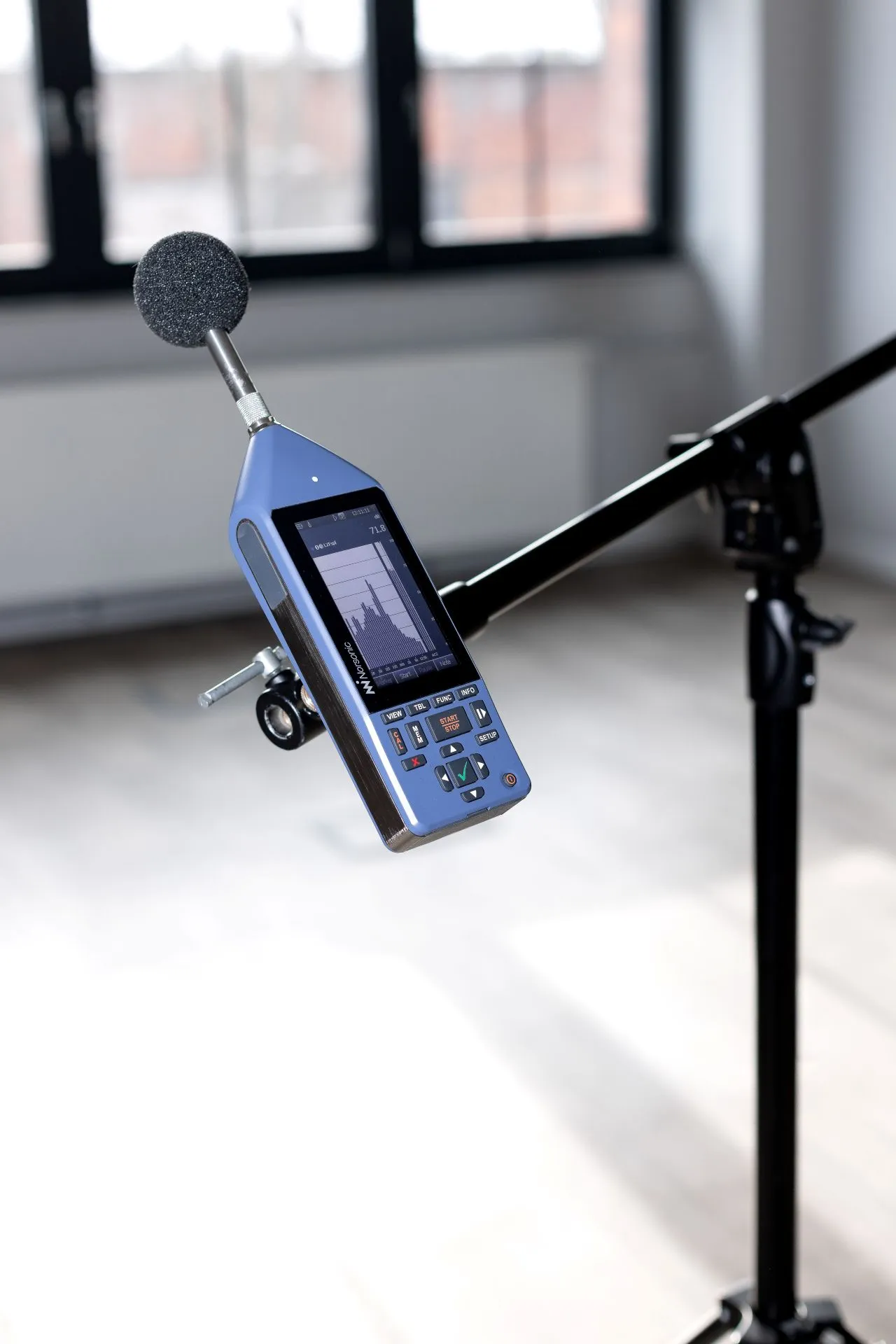 A close-up of a precision Norsonic sound level meter used for measurements in interior acoustics projects.