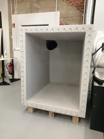 Interior of a reverberation chamber for acoustic insulation measurements — inside view with a mounted loudspeaker.